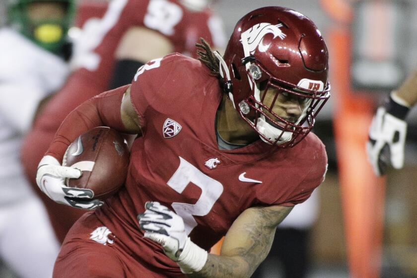 Washington State running back Deon McIntosh (3) carries the ball during the second half.
