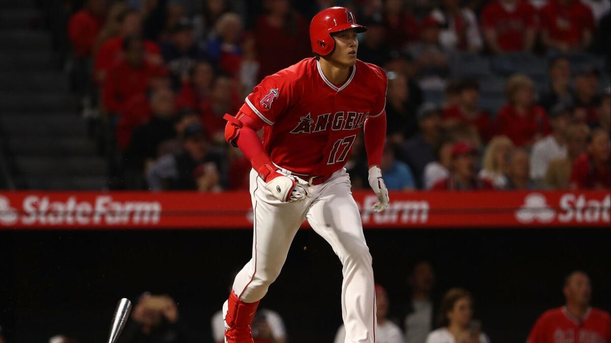 Angels' Shohei Ohtani (17) watches the ball leave the park for a solo homerun on his way to first base in the second inning against the New York Yankees at Angel Stadium on Friday.