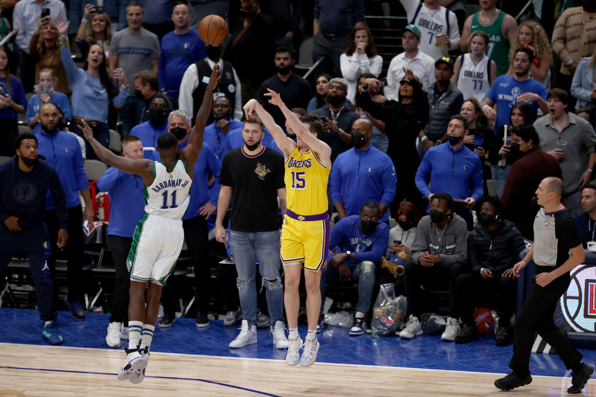 Lakers guard Austin Reaves shoots the winning shot over Dallas Mavericks small forward Tim Hardaway Jr. in overtime.