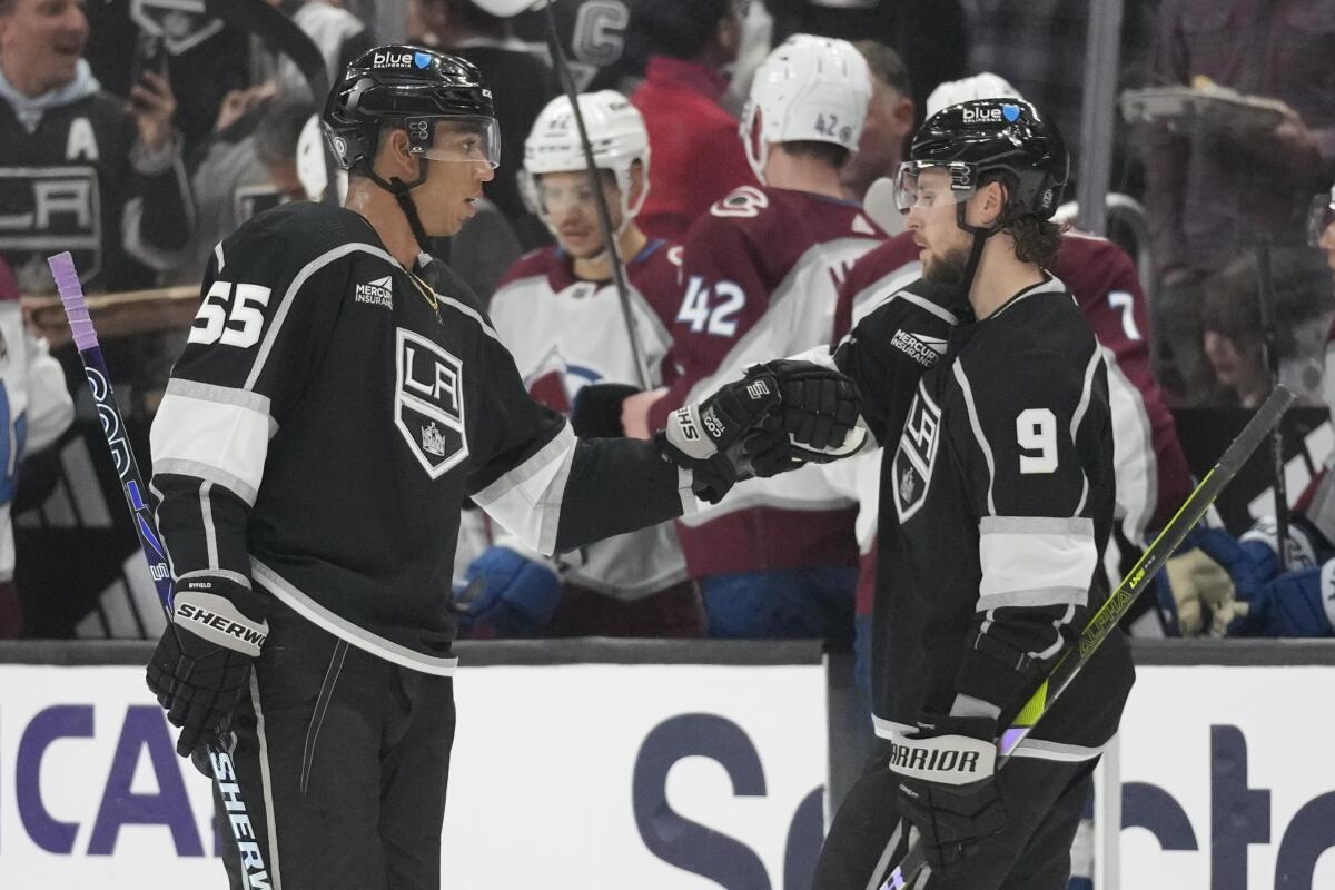 Kings center Quinton Byfield, left, celebrates with center Adrian Kempe after scoring against the Colorado Avalanche.