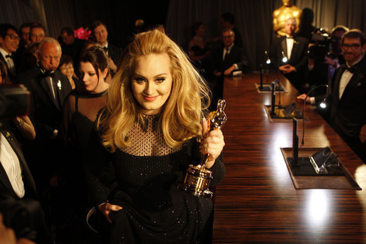 British soul singer Adele, shown with her best-song Oscar from the Academy Awards, had the world's best-selling album of 2012 with "21."