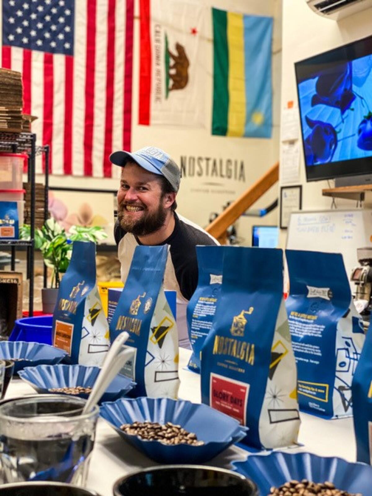Brandt Radowski, head roaster for Nostalgia Coffee Roasters, shows off a selection of Nostalgia coffees.