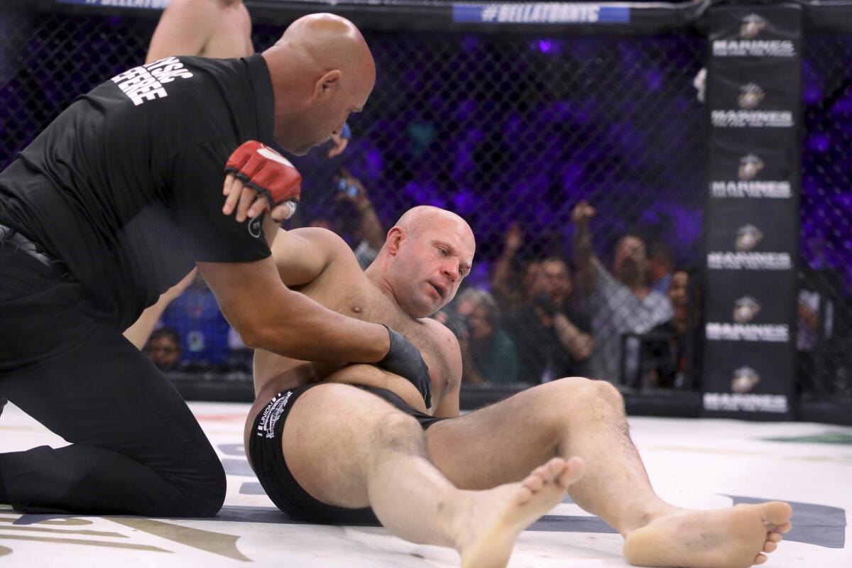 Fedor Emelianenko is tended to by the referee after being stopped by Matt Mitrione during the first round of the fight at Bellator NYC.