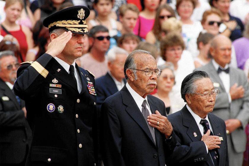 George Sakato, right, takes part in a wreath ceremony for Asian American, Native American and Pacific Islander Medal of Honor recipients in 2000. With him are Army Maj. Gen. Robert R. Ivany, left, and fellow recipient Rudolph Davila.