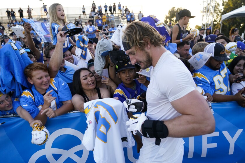 Chargers outside linebacker Joey Bosa signs autographs for fans after practice Sunday.