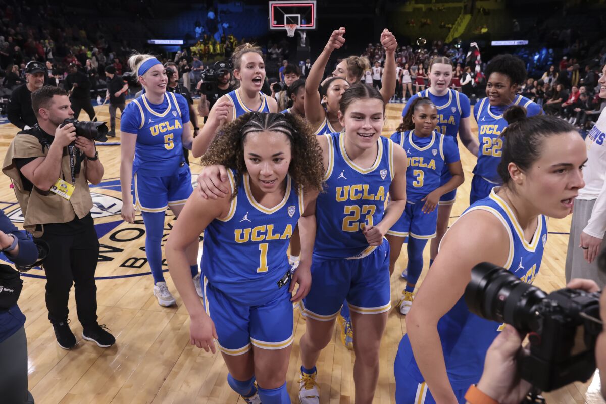 UCLA guard Kiki Rice and forward Gabriela Jaquez head off the court after UCLA's win over Stanford.
