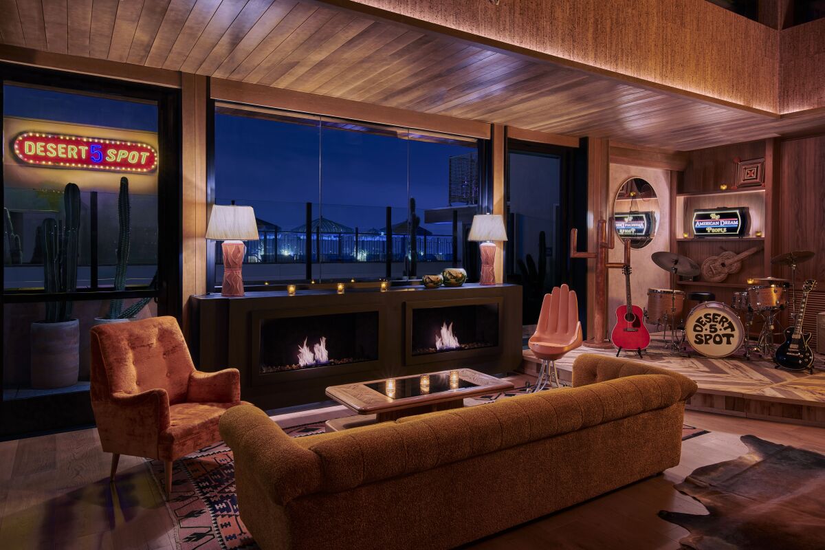 A western-themed lounge space with leather couches and chairs and a view of Hollywood