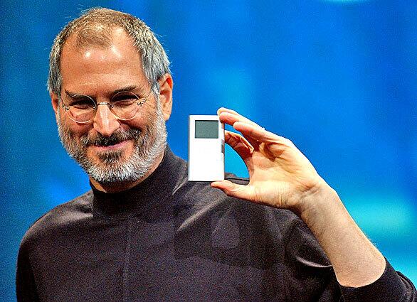 Jobs displays the new iPod Mini at the 2004 Macworld Conference and Expo in San Francisco.