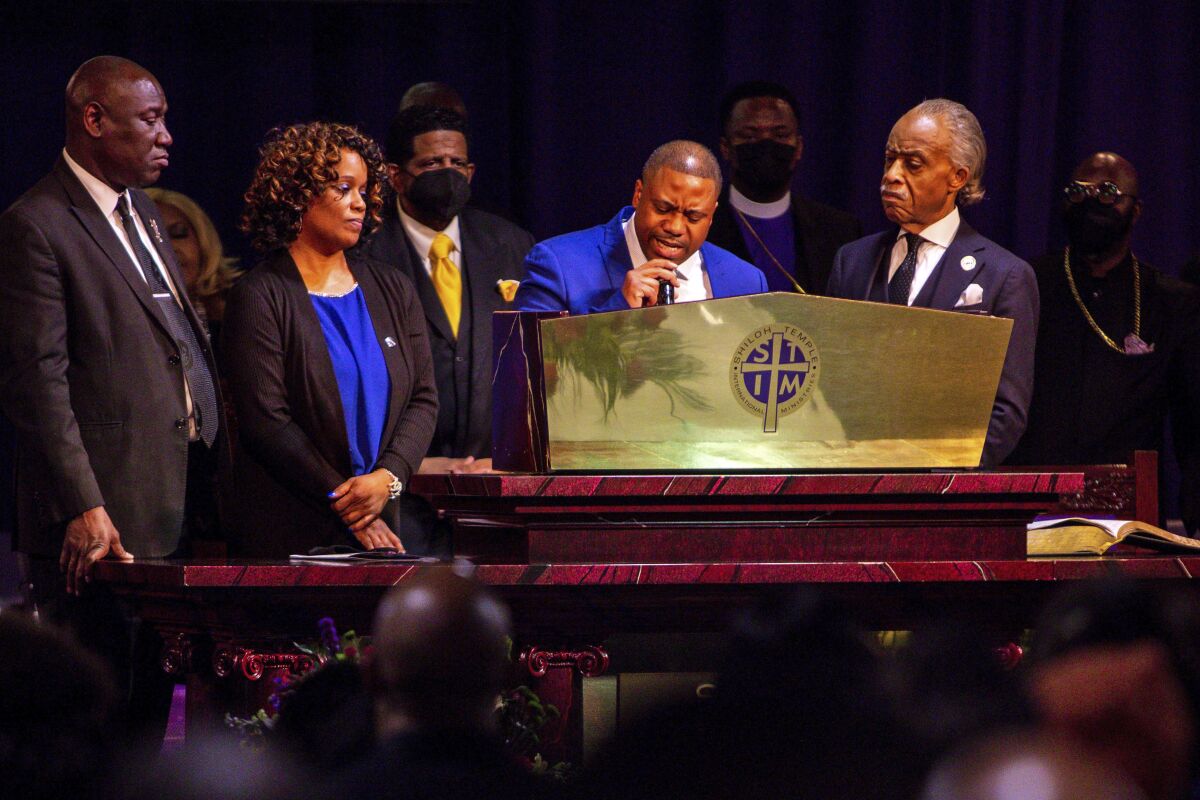 Andre Locke, Amir Locke's father, speaks during the funeral for Amir Locke at Shiloh Temple International Ministries, Thursday, Feb. 17, 2022, in Minneapolis, Minn. Locke was killed Feb. 2 by Minneapolis police as they executed a no-knock search warrant. (AP Photo/Nicole Neri)