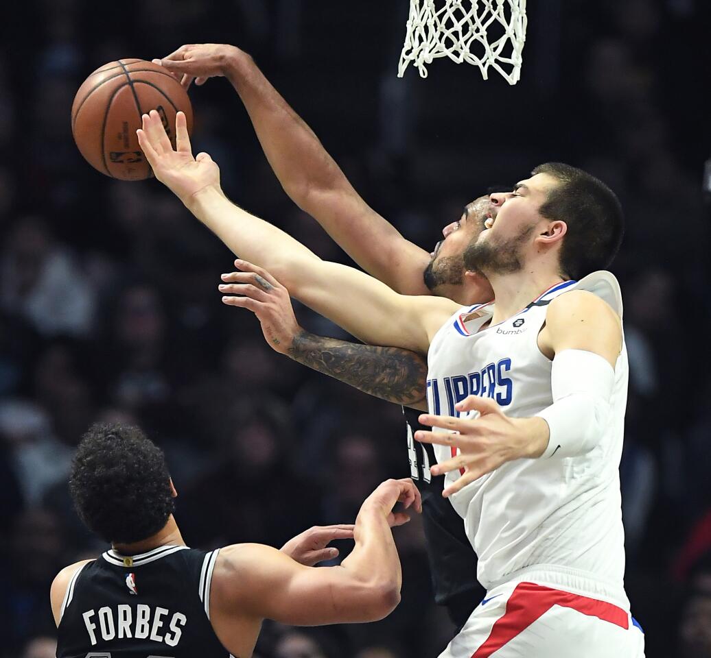 Clippers center Ivica Zubac and Spurs center Trey Lyles battle for a rebound during the second quarter.