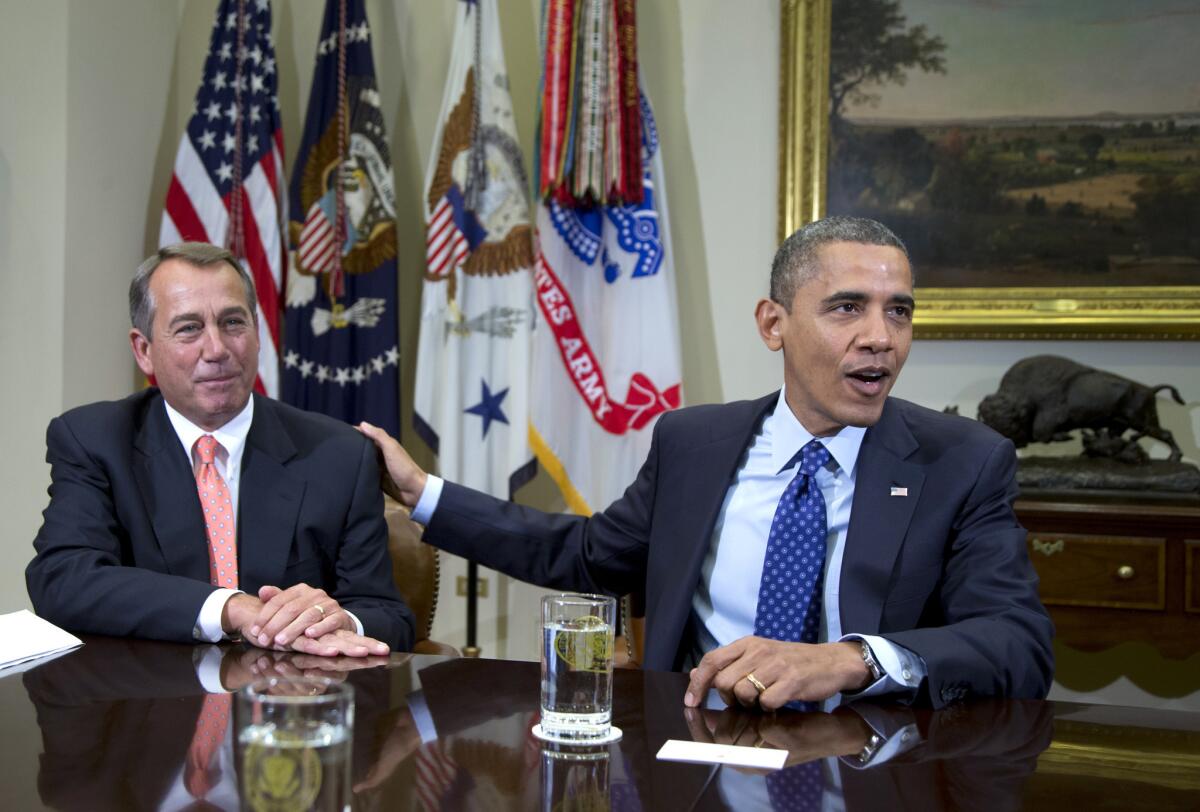 President Barack Obama acknowledges House Speaker John Boehner of Ohio while speaking to reporters in the Roosevelt Room of the White House in Washington, as he hosted a meeting of the bipartisan, bicameral leadership of Congress to discuss the deficit and economy.