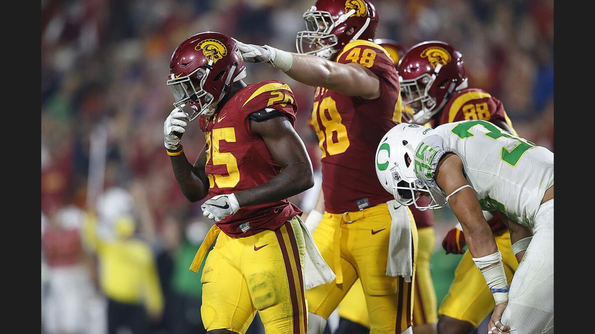 Trojans tailback Ronald Jones is congratulated by teammate Taylor McNamera after scoring a fourth-quarter touchdown against the Ducks at the Coliseum.