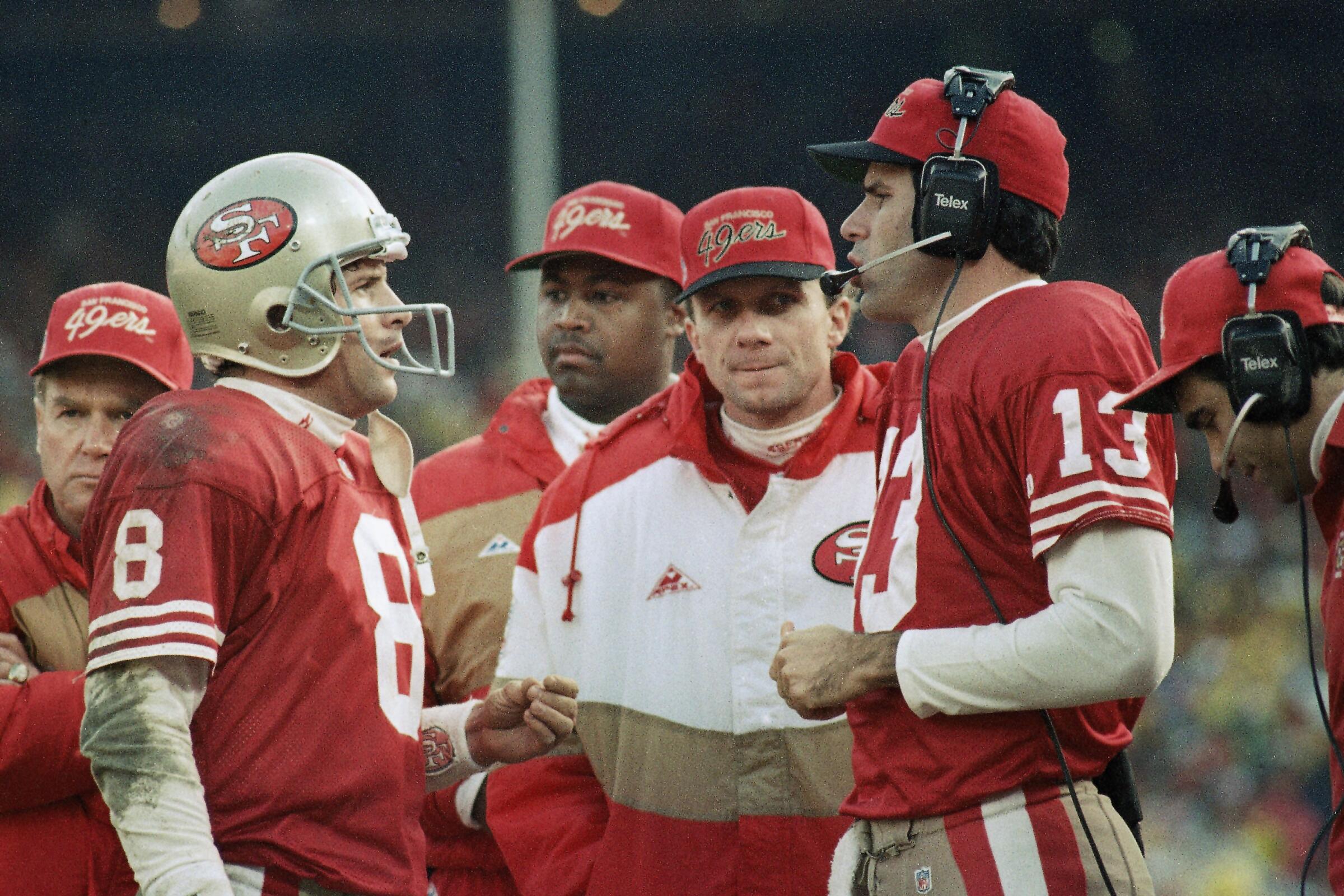Steve Young (8), Steve Bono (13) and Joe Montana, center, on 49ers' sideline in 1993.