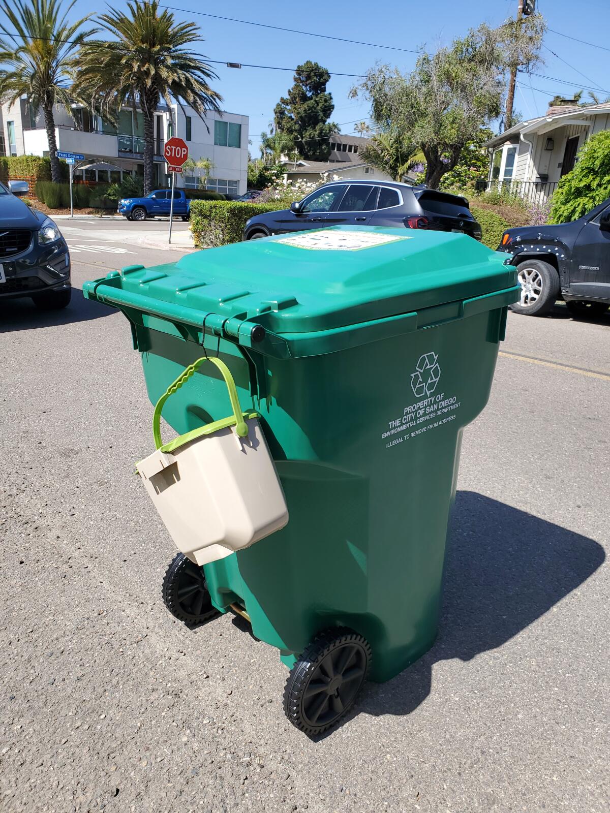 A green bin and kitchen pail are freshly delivered in La Jolla Shores.