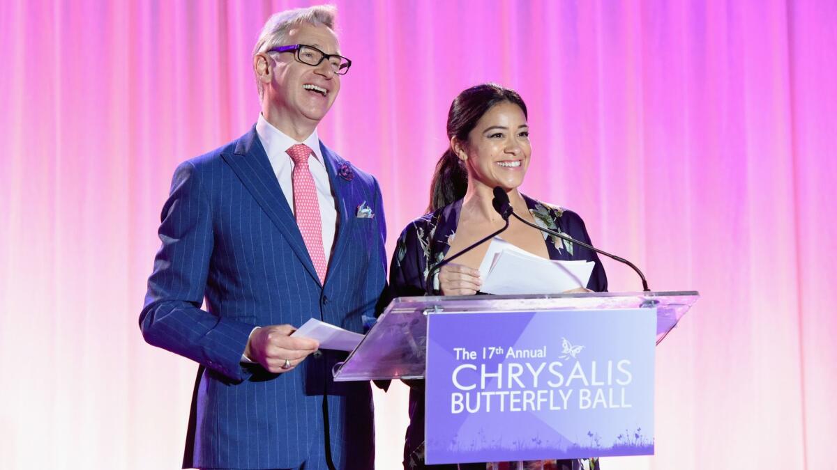 Paul Feig, left, and Gina Rodriguez speak onstage at the 17th Chrysalis Butterfly Ball on June 2.