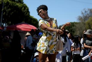 LOS ANGELES, CA - JUNE 18: Tiya (cq) Like Fiya (cq), of Columbus, Ohio, dances to a drum circle at the Leimert Park Juneteenth Festival in Leimert Park Village on Saturday, June 18, 2022 in Los Angeles, CA. Community-led arts and culture festival - commemorating June 19, 1865 when enslaved Black people in Galveston, Texas, were informed that they were free at last. (Gary Coronado / Los Angeles Times)