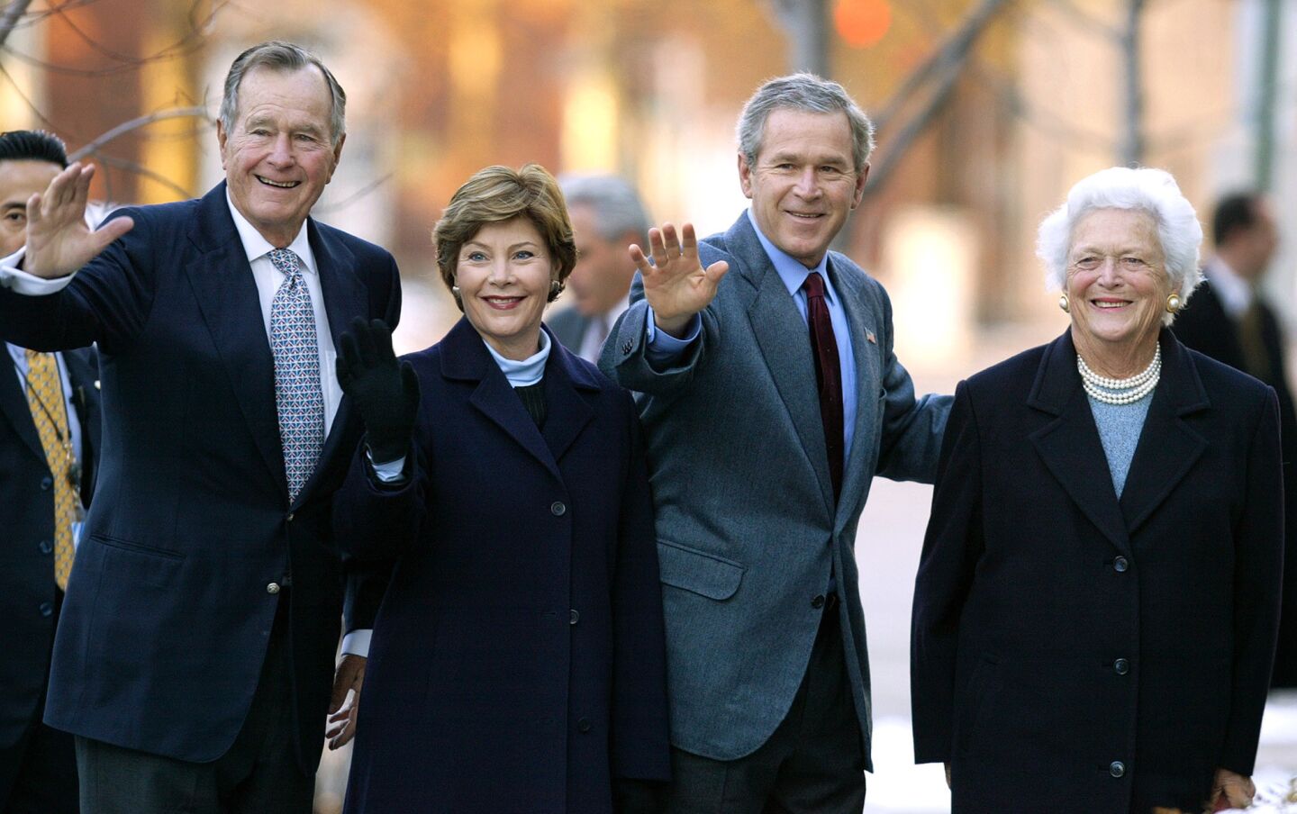 Former President George H.W. Bush, First Lady Laura Bush, President George W. Bush and former First Lady Barbara Bush wave to reporters outside St. John's church in Washington in 2003.