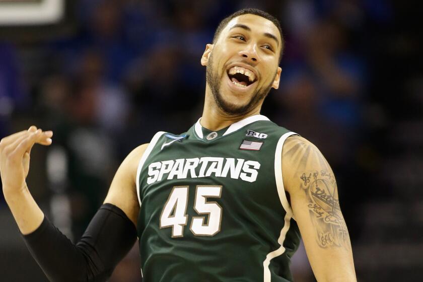 Michigan State's Denzel Valentine celebrates the Spartans' 60-54 win over Virginia in the third round of the NCAA tournament on Sunday.