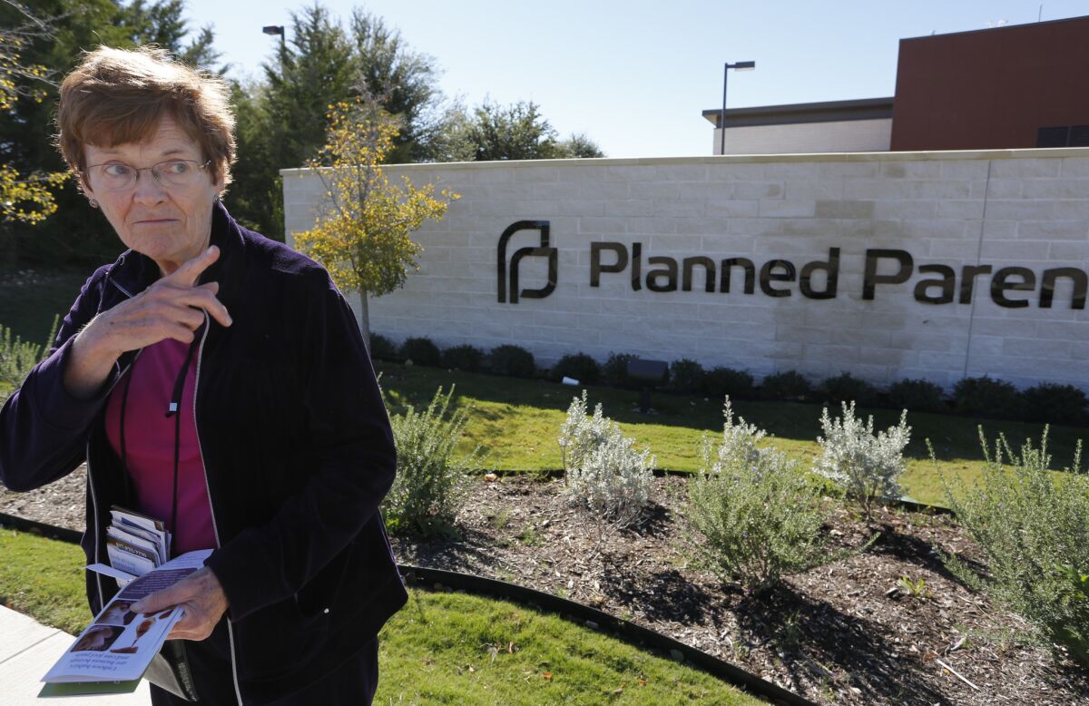 Marian Honquest promotes alternatives to abortion in front of Planned Parenthood in Fort Worth, Texas.