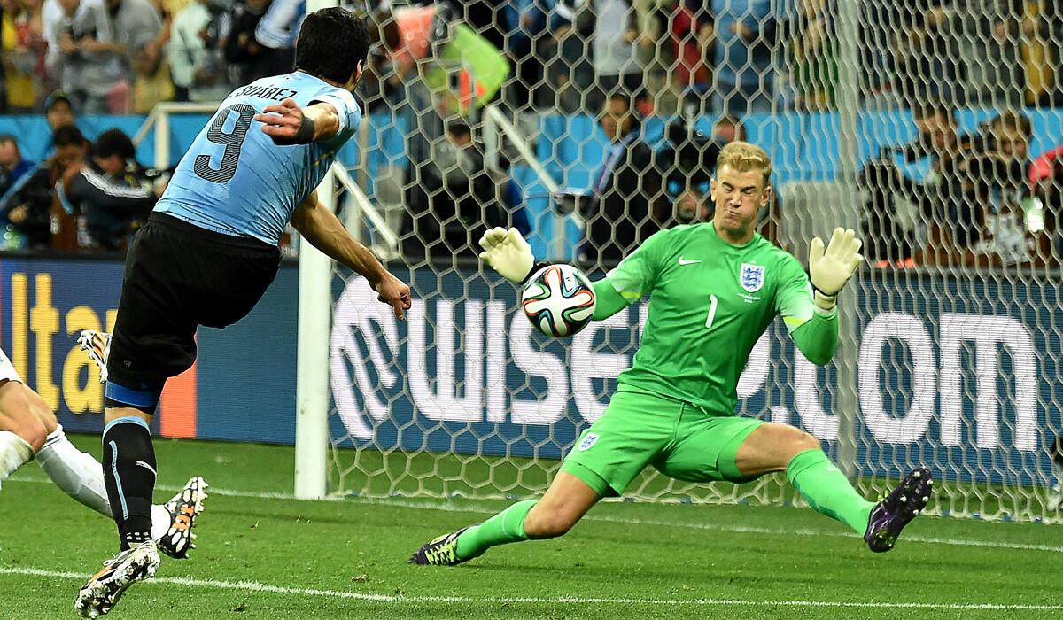 Uruguay forward Luis Suarez puts a shot past England goalkeeper Joe Hart in the second half of their World Cup Group D game on Thursday at Corinthians Arena in Sao Paulo, Brazil.