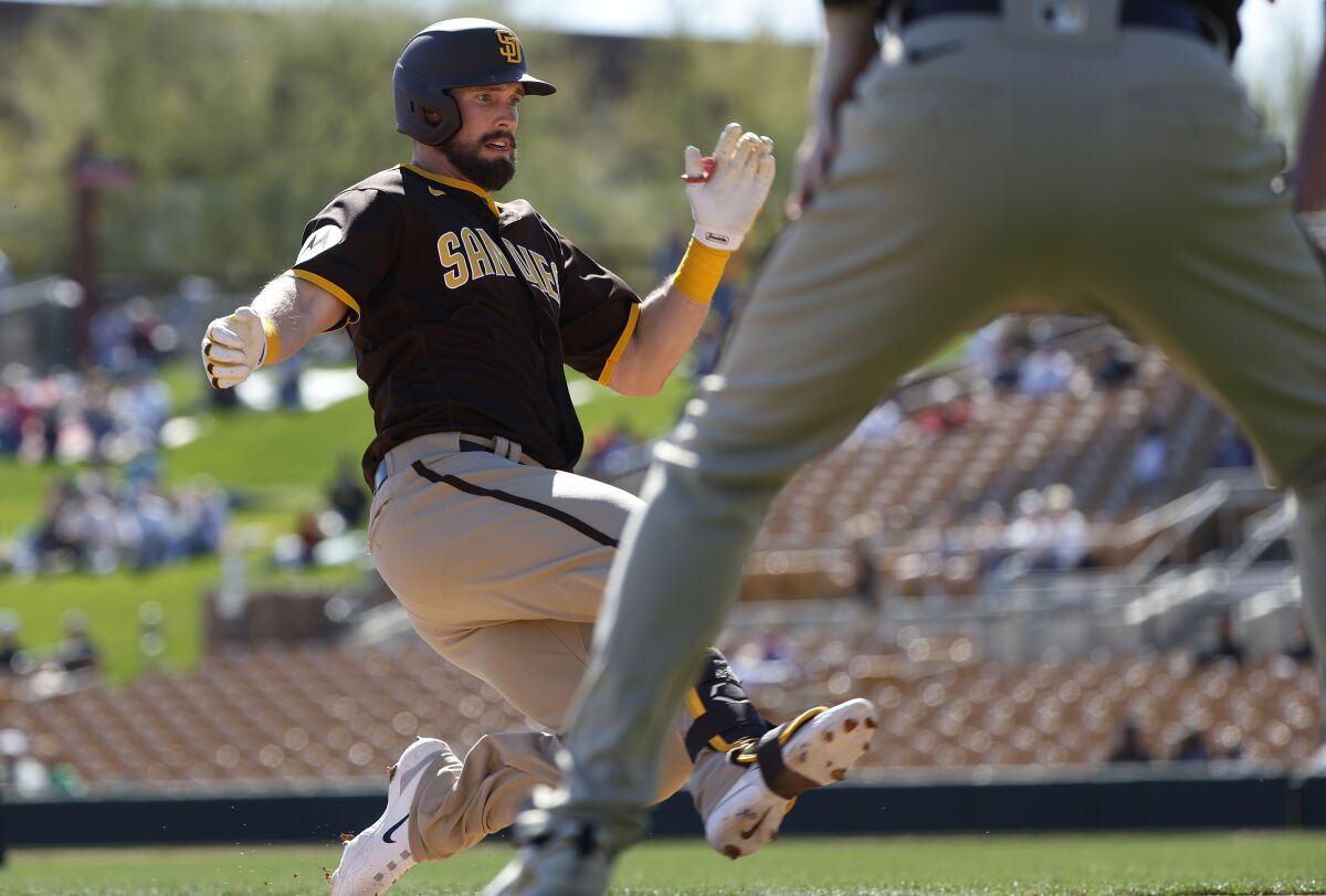 David Dahl slides into third with a triple in a spring training game against the White Sox.