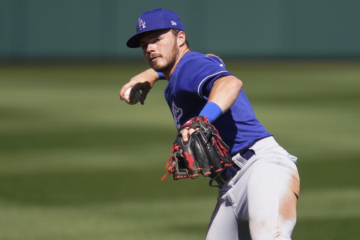 Dodgers second baseman Gavin Lux throws during a spring training game.