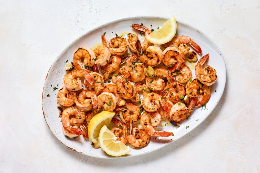 Camarones a la Plancha, cooked on a flattop outdoor griddle, combine shrimp roasted on a plancha and camarones al ajillo.