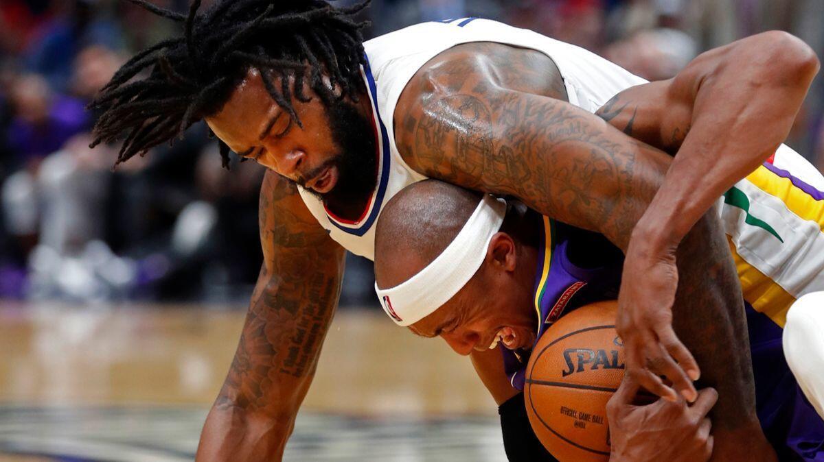 DeAndre Jordan battles New Orleans forward Dante Cunningham for the ball in the first half on Sunday in New Orleans. The Clippers won 112-103.