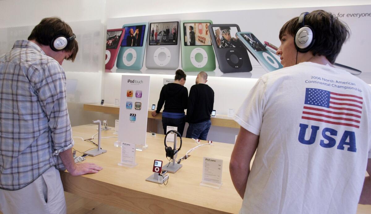An antitrust lawsuit against Apple will continue, despite all plaintiffs in the case being disqualified. Above, customers try out the Apple iPod Nano at a store in Palo Alto in 2007.