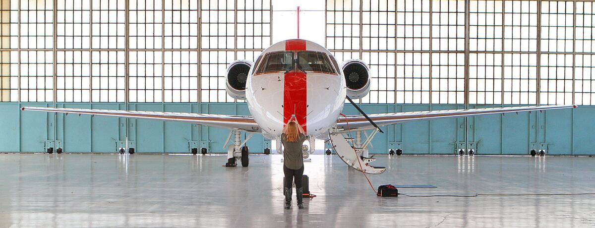 Sarah Theiss, a digital marketing intern with Irvine-based JetSuite, takes a photo to publicize JetSuiteX, a new charter service for the private jet company that will connect Burbank to Concord in the East Bay.