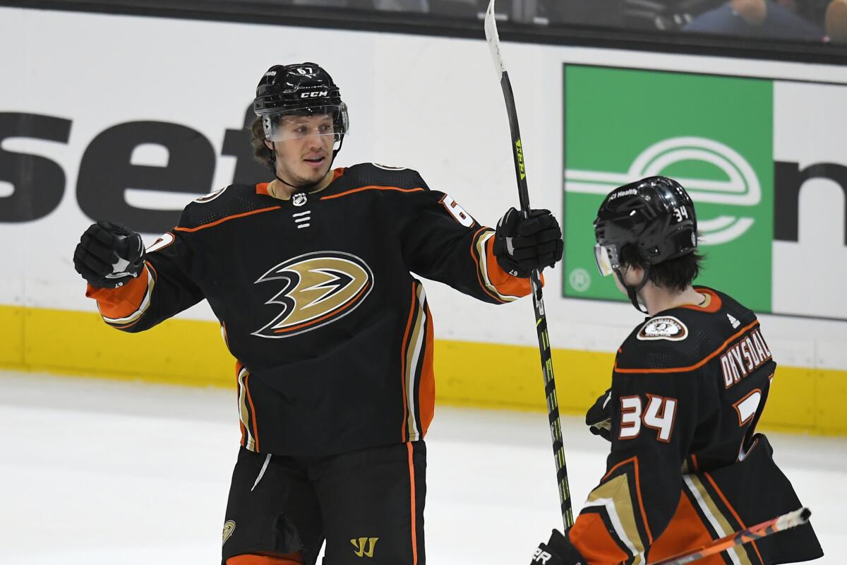 Ducks left wing Rickard Rakell is congratulated by Jamie Drysdale after scoring a goal.