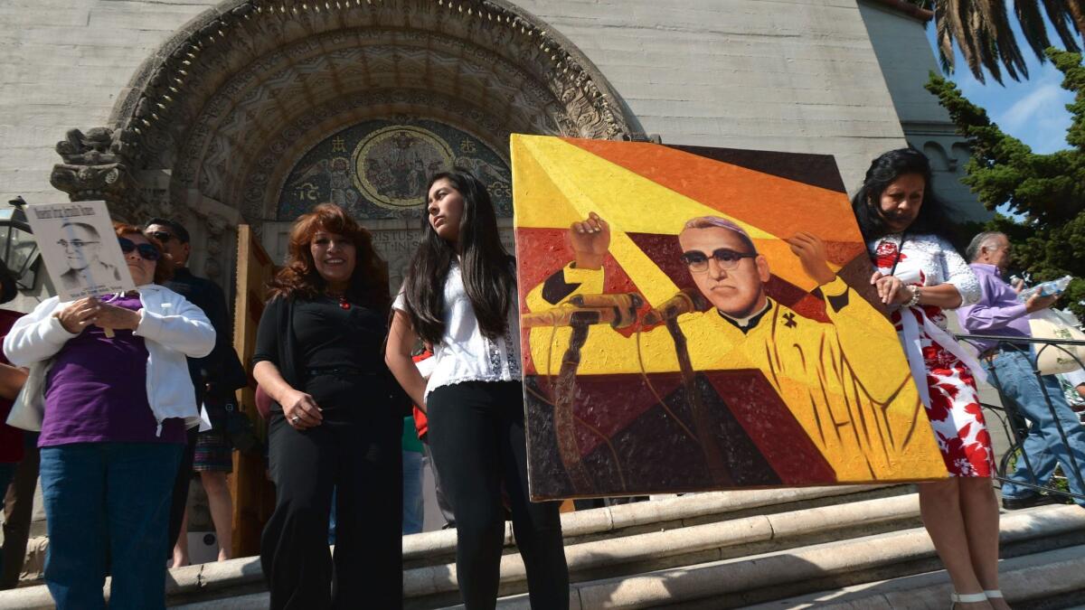 Three items with ties to Salvadoran Archbishop Óscar Arnulfo Romero, pictured here in a painting held by parishioners after his beatification, are available for public viewing Sunday at the Cathedral of Our Lady of the Angels.