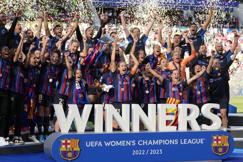 Barcelona's captain Alexia Putellas lifts the trophy after winning the Women's Champions League final soccer match between FC Barcelona and VfL Wolfsburg at the PSV Stadion in Eindhoven, Netherlands, Saturday, June 3, 2023. Barcelona won 3-2. (AP Photo/Martin Meissner)