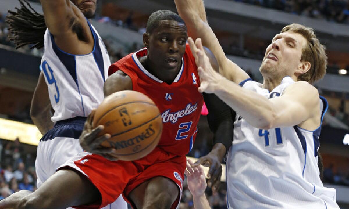 Clippers point guard Darren Collison, center, passes between Dallas Mavericks teammates Jae Crowder, left, and Dirk Nowitzki during a win on Jan. 3. Collison is averaging 18.6 points per game when starting in place of Chris Paul.