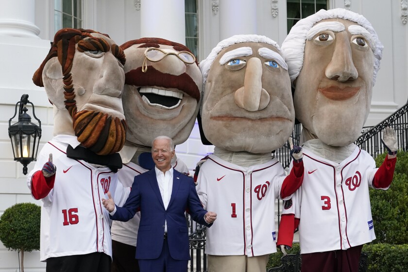 President Joe Biden visits with members of the Washington Nationals' Racing Presidents after speaking at an Independence Day celebration on the South Lawn of the White House, Sunday, July 4, 2021, in Washington. (AP Photo/Patrick Semansky)