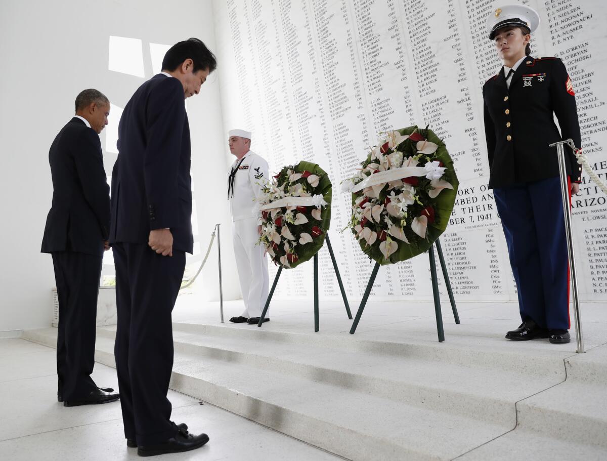 President Barack Obama and Japanese Prime Minister Shinzo Abe participate in a wreath laying ceremony at the USS Arizona Memorial, part of the World War II Valor in the Pacific National Monument, in Joint Base Pearl Harbor-Hickam, Hawaii, adjacent to Honolulu, Hawaii, Tuesday, Dec. 27, 2016, as part of a ceremony to honor those killed in the Japanese attack on the naval harbor.