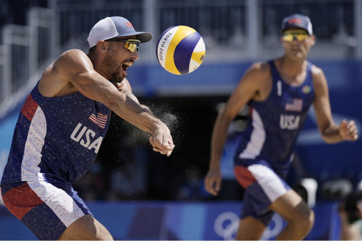 Nick Lucena, left, and Phil Dalhausser compete against a team from Qatar ranked No. 1 in the world at the Olympics on Sunday.