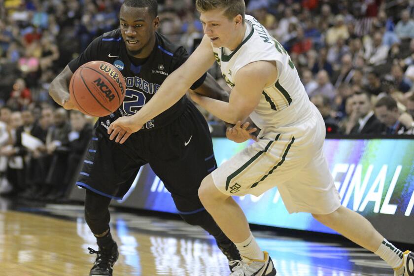 Georgia State guard Ryann Green and Baylor guard Austin Mills, right, chase a loose ball during the second half of the Panthers' NCAA tournament victory over the Bears, 57-56.