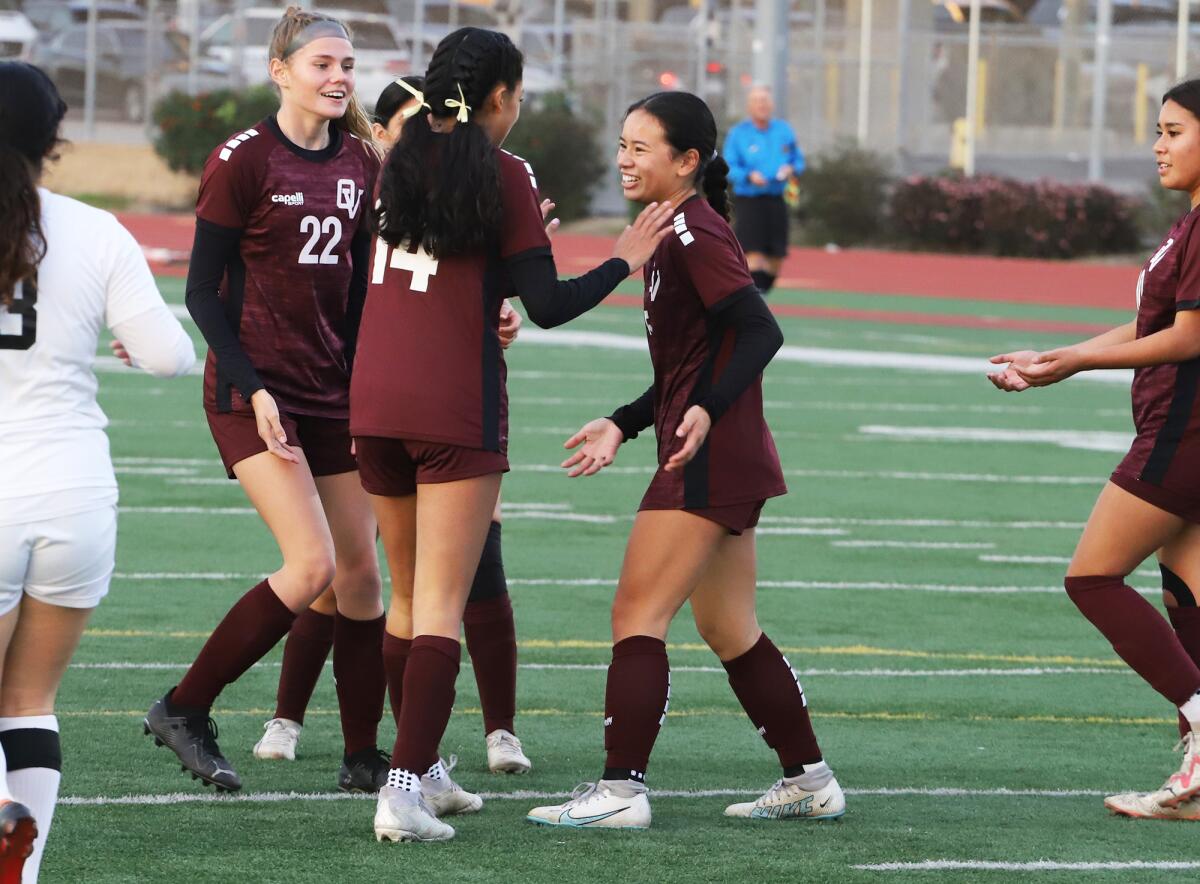 The Ocean View High girls' soccer team celebrates with Marisa Vo. 