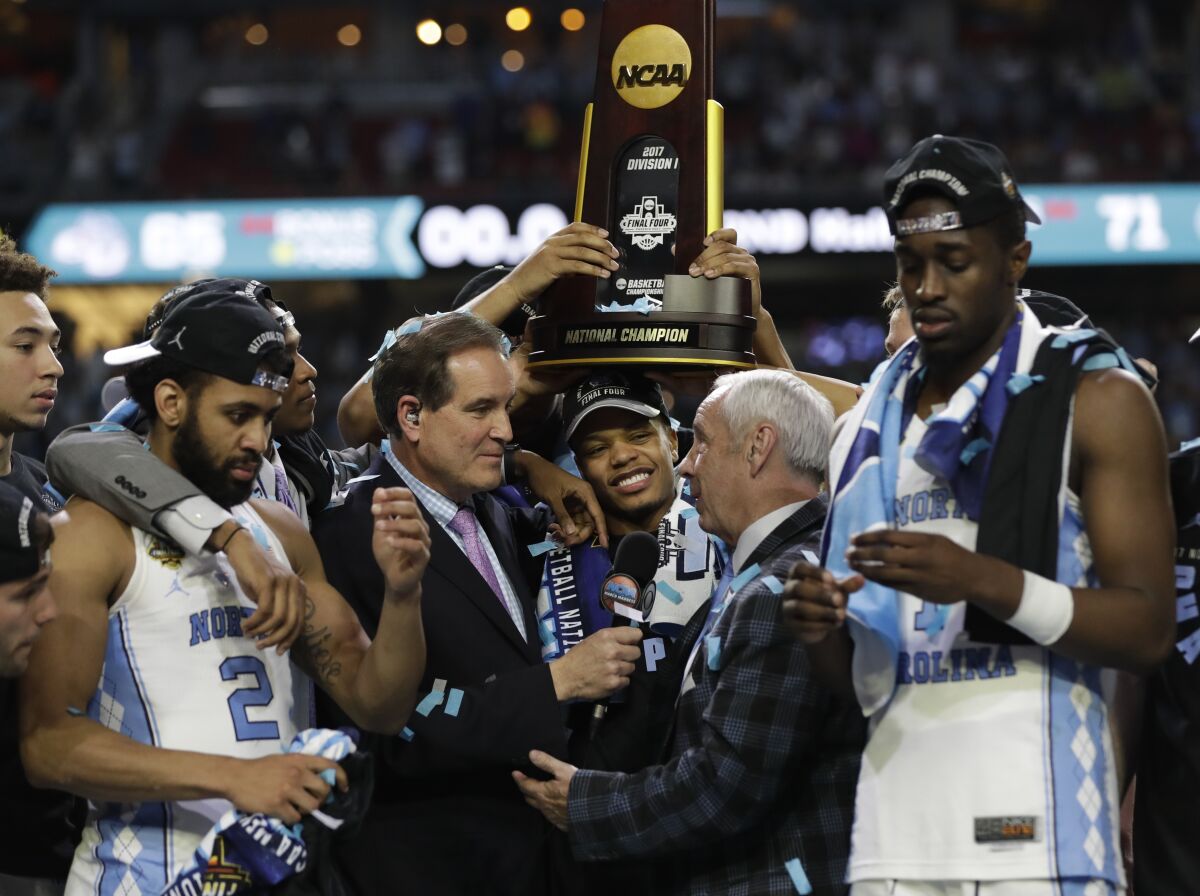 North Carolina coach Roy Williams is interviewed as he celebrates with his team following a win over Gonzaga.