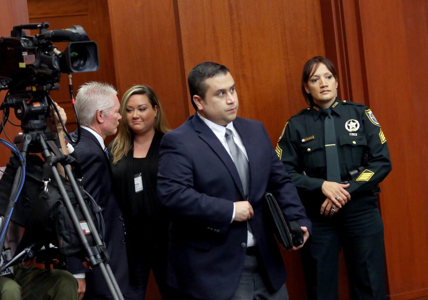 Shellie Zimmerman and her husband George Zimmerman enter the courtroom after a recess in the afternoon in Seminole circuit court on the 4th day of George Zimmerman's trial, in Sanford, Fla., Thursday, June 13, 2013. Zimmerman is accused in the fatal shooting of Trayvon Martin. (Jacob Langston/Orlando Sentinel/POOL)