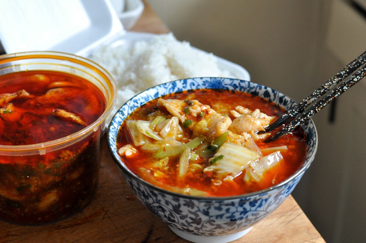 Two orders of boiled fish in chili sauce, brought home from Sichuan Impression.