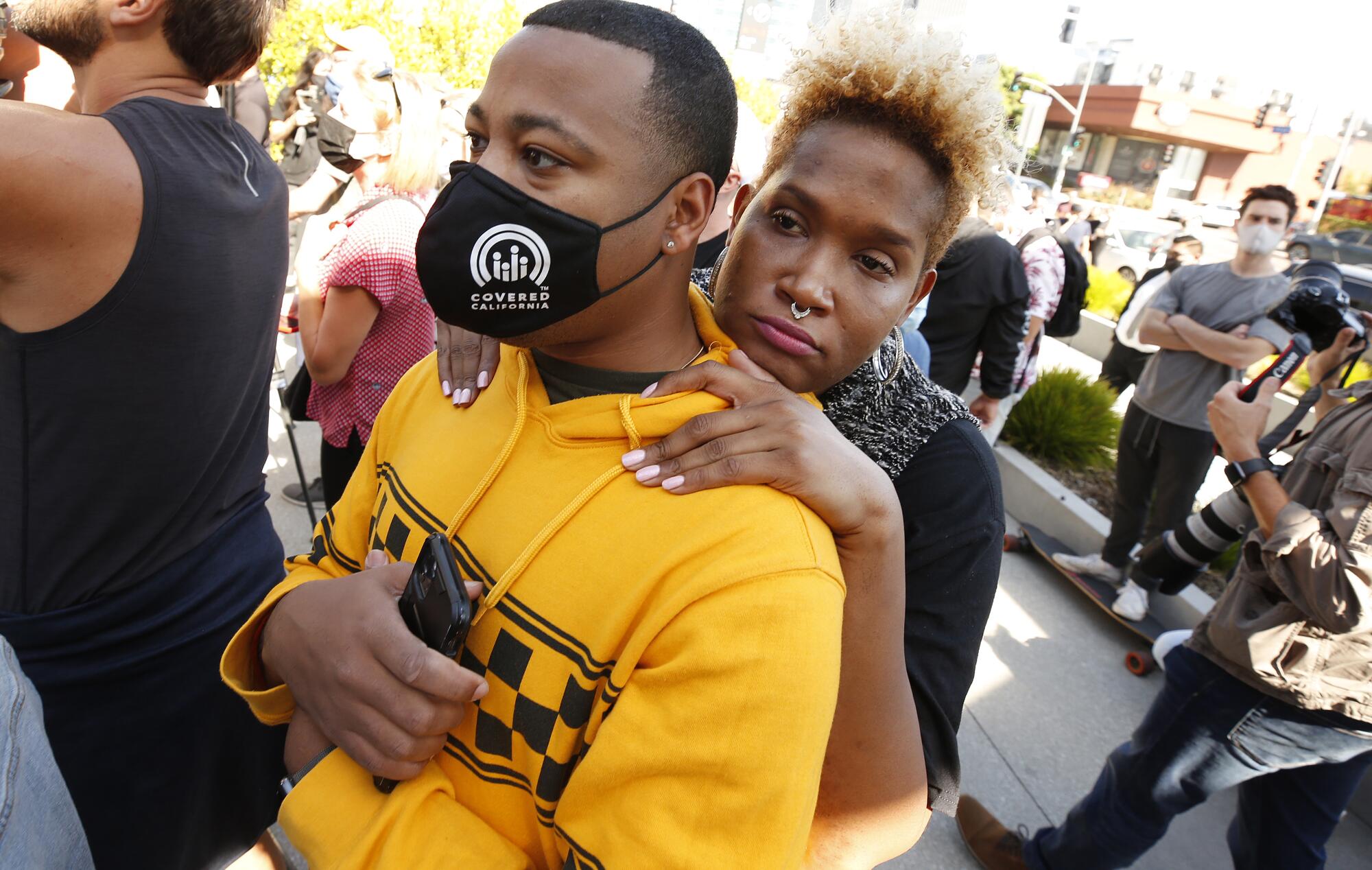 Activists Neverending Nina, right, hugs Pierre Phipps, left, at the employee walkout at Netflix.