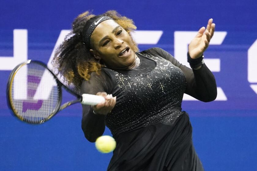 Serena Williams, of the United States, returns a shot to Danka Kovinic.