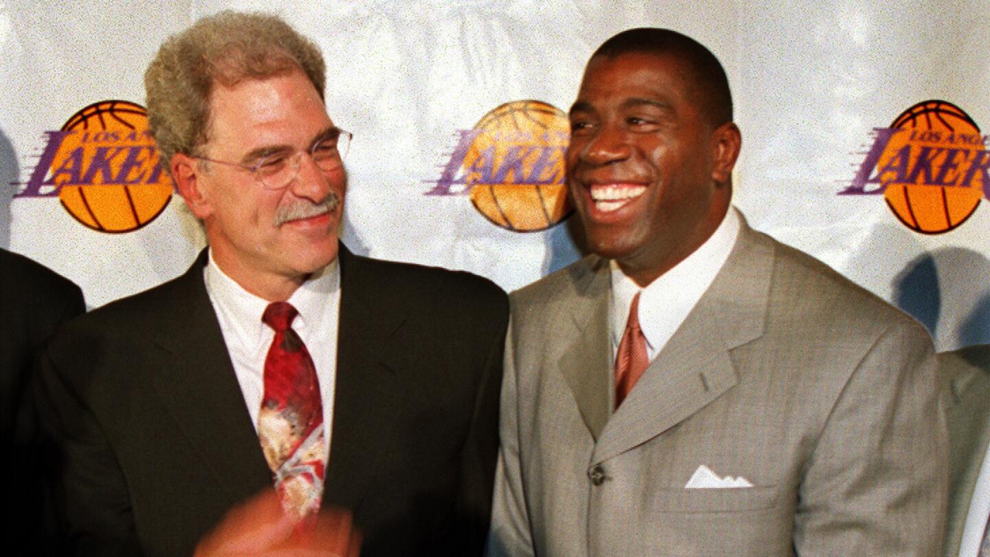 Lakers Coach Phil Jackson, left, shares a laugh with Lakers great Magic Johnson during a news conference in Beverly Hills in June 1999.