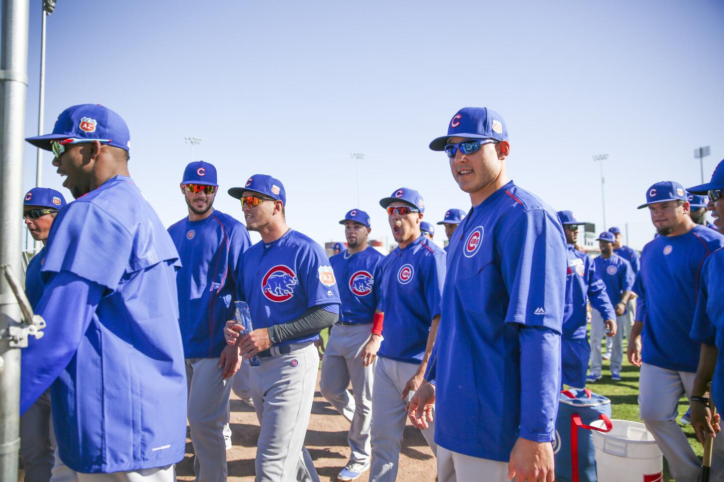 Cubs players walk of the field during spring training, Feb. 26, 2016.
