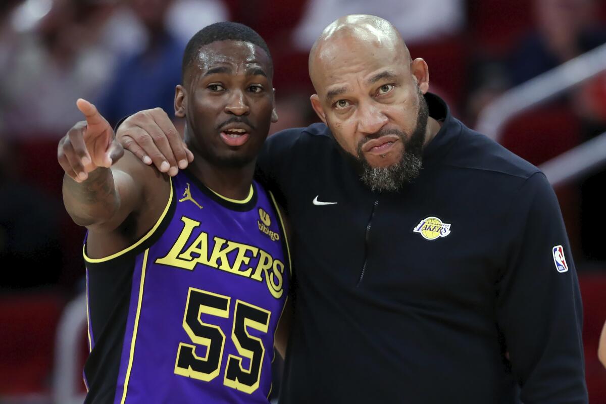 D'Moi Hodge talks with Lakers coach Darvin Ham against the Houston Rockets on Wednesday.
