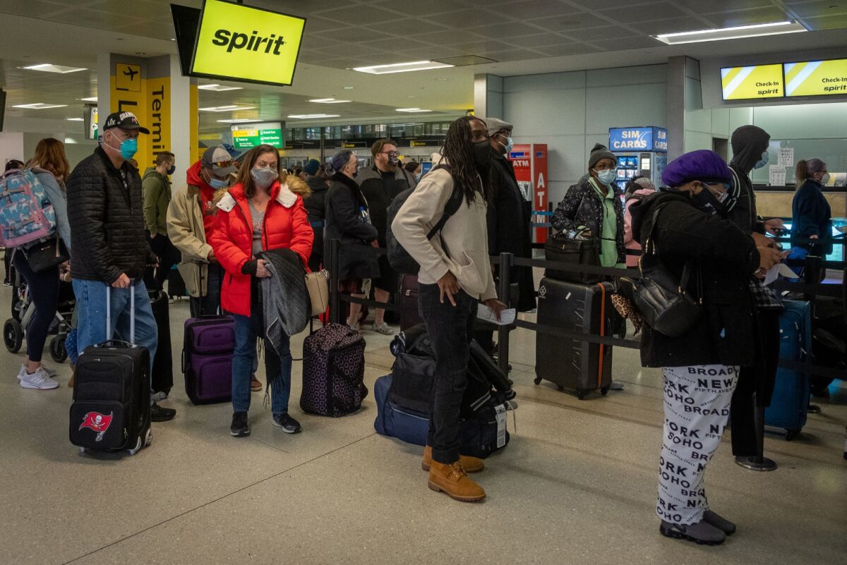Travelers stand in line at a Spirit Airlines check-in counter at Newark Liberty International Airport in New Jersey.