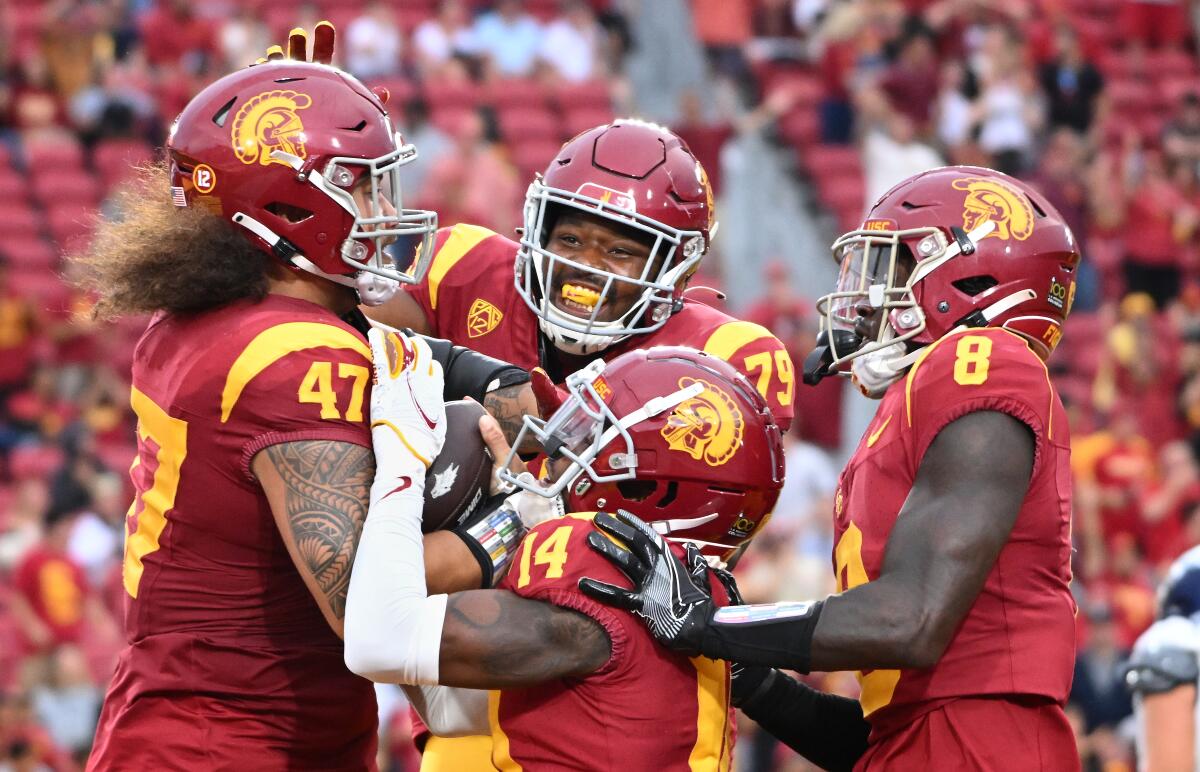 USC defensive lineman Stanley Ta’ufo’ou celebrates with teammates after returning a fumble for a touchdown.