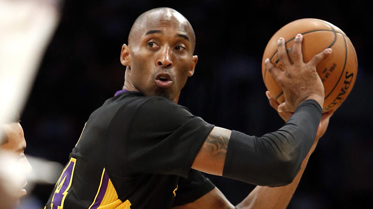 Lakers star Kobe Bryant looks to pass during a game against the Clippers in 2013.